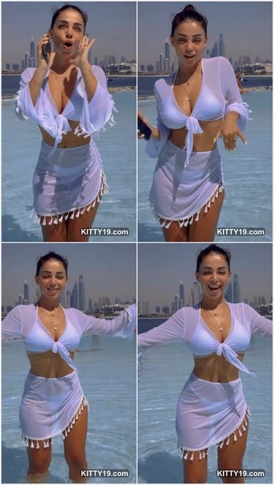 Meri Babayan tits in an elegant dress at an event, she exudes sophistication. The background hints at a luxurious and exclusive setting